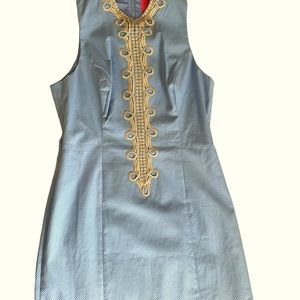 Blue Lilly Pulitzer shift dress with gold trim.